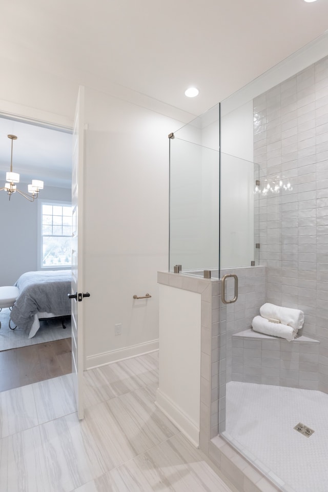 bathroom featuring an enclosed shower and a chandelier