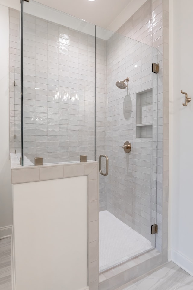 bathroom featuring a shower with shower door