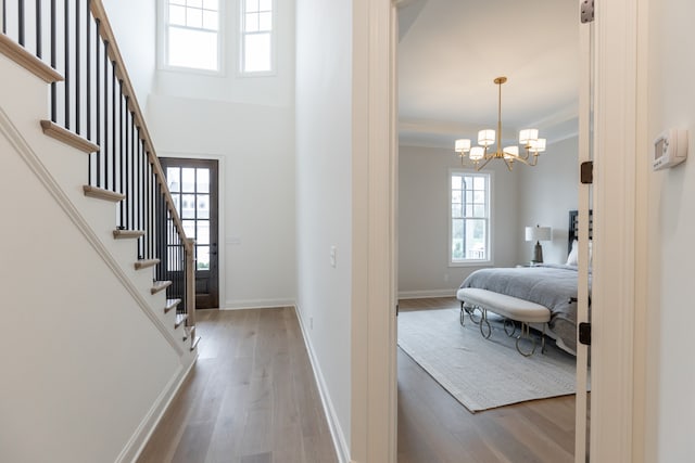 interior space featuring hardwood / wood-style floors and an inviting chandelier