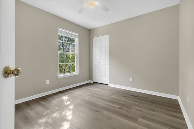 unfurnished room with hardwood / wood-style flooring and ceiling fan