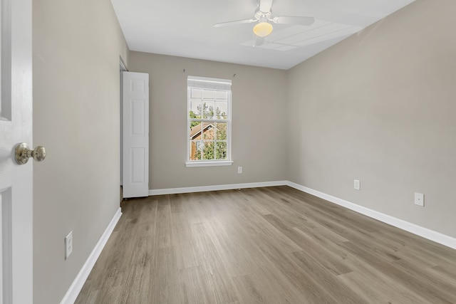 spare room with ceiling fan and light wood-type flooring