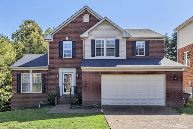 view of front property with a front yard and a garage