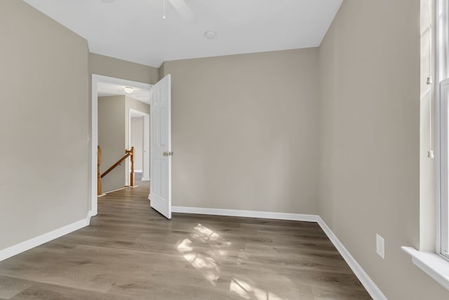 unfurnished room featuring ceiling fan and wood-type flooring