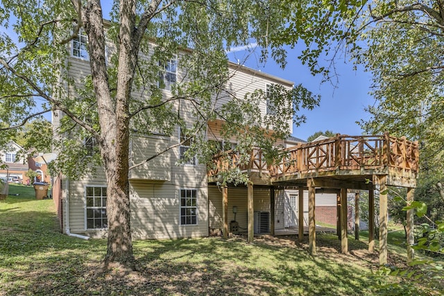 back of house with a wooden deck, a yard, and cooling unit