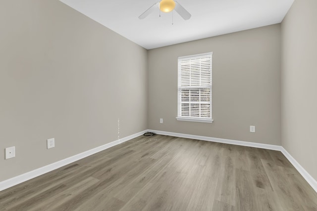 empty room featuring ceiling fan and light hardwood / wood-style floors