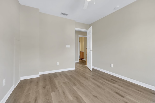 unfurnished room with ceiling fan and light wood-type flooring