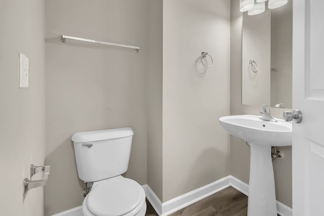 bathroom featuring hardwood / wood-style flooring and toilet