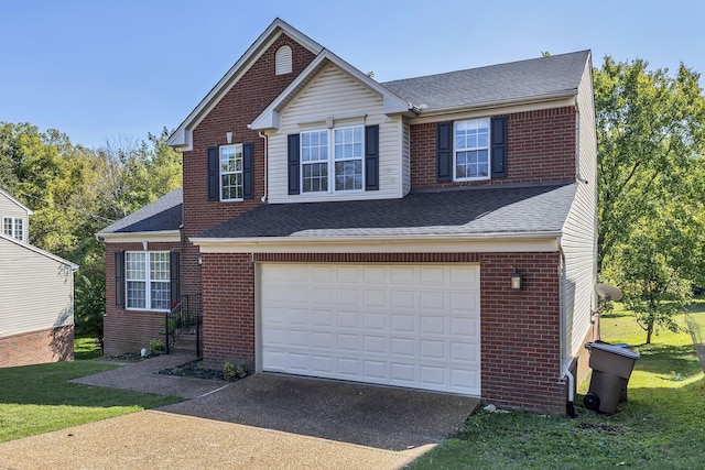 view of front of property featuring a garage and a front lawn