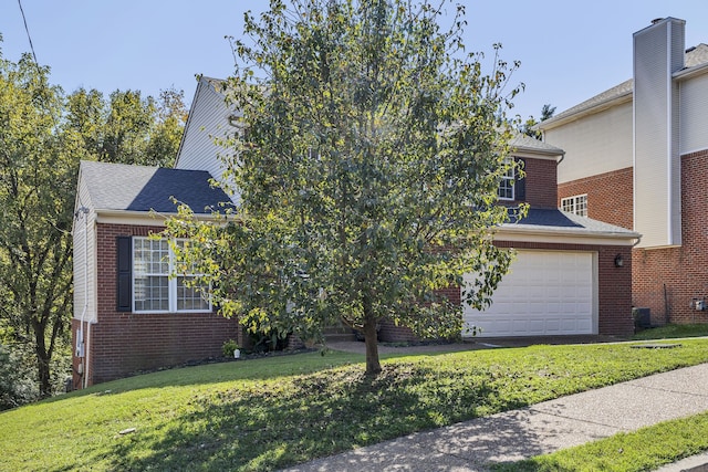 view of front facade with a front yard and a garage