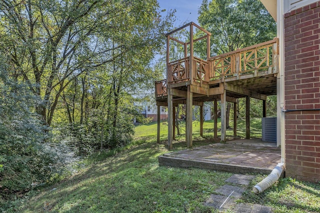 view of yard featuring a wooden deck and a patio