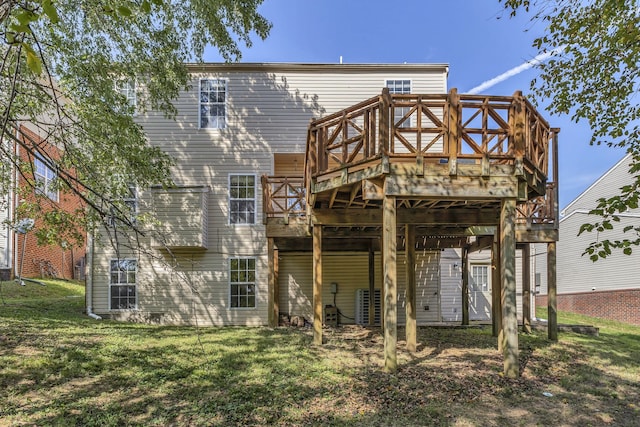 back of property featuring a wooden deck and a yard