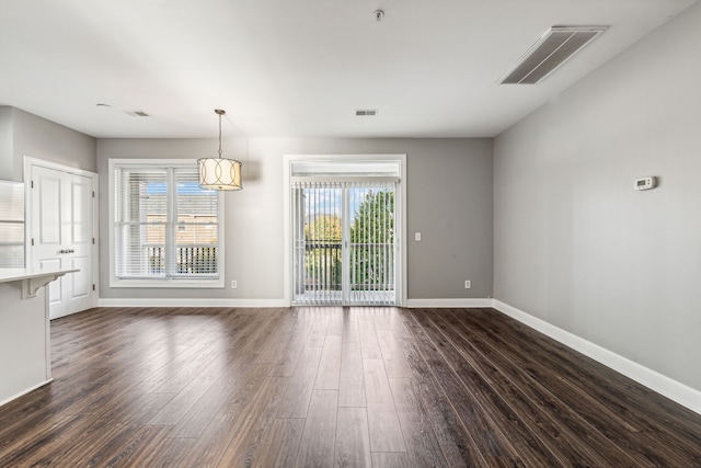 unfurnished dining area with dark hardwood / wood-style flooring