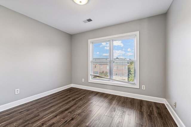 spare room with dark hardwood / wood-style flooring