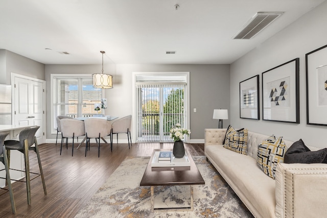 living room featuring dark wood-type flooring