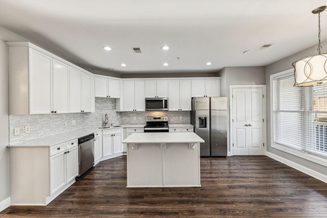 3200 Long Blvd Unit 4, Nashville, TN 37203 - kitchen featuring appliances with stainless steel finishes, decorative backsplash, white cabinetry, dark wood-style floors, and recessed lighting
