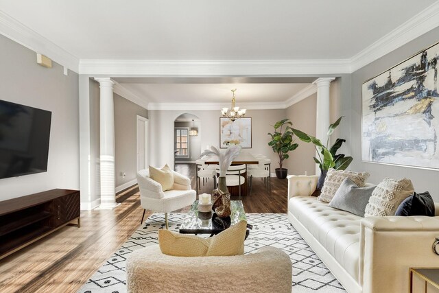 3200 Long Blvd Unit 4, Nashville, TN 37203 - living area with decorative columns, light wood finished floors, crown molding, a chandelier, and arched walkways
