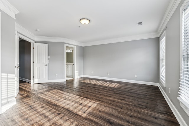 spare room featuring dark hardwood / wood-style flooring and ornamental molding