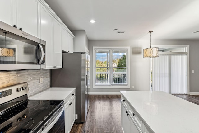 3200 Long Blvd Unit 4, Nashville, TN 37203 - kitchen featuring appliances with stainless steel finishes, dark wood-type flooring, white cabinetry, decorative backsplash, and recessed lighting