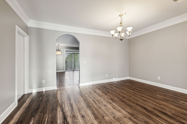 empty room with a chandelier, crown molding, and dark wood-type flooring