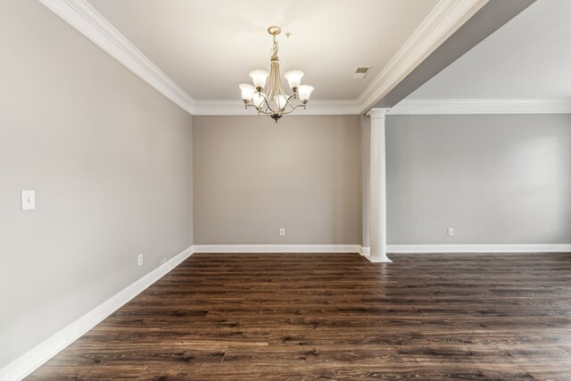 empty room featuring dark wood-type flooring, an inviting chandelier, decorative columns, and ornamental molding