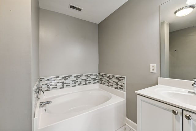 bathroom with vanity and a tub