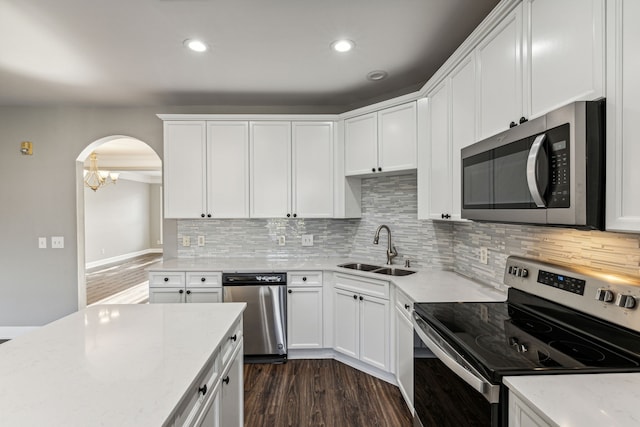 kitchen featuring white cabinets, appliances with stainless steel finishes, dark wood-type flooring, and sink