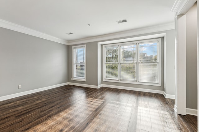 spare room with dark hardwood / wood-style flooring and crown molding