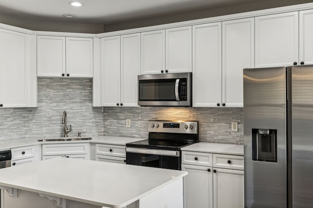 kitchen with white cabinetry, sink, and appliances with stainless steel finishes