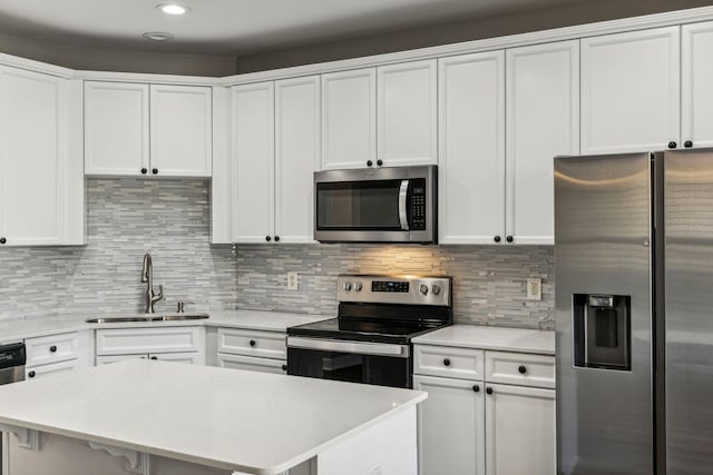 3200 Long Blvd Unit 4, Nashville, TN 37203 - kitchen with appliances with stainless steel finishes, light countertops, white cabinetry, backsplash, and recessed lighting