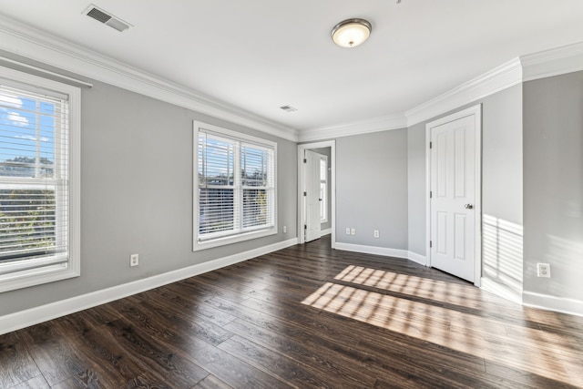 unfurnished bedroom featuring crown molding and dark wood-type flooring