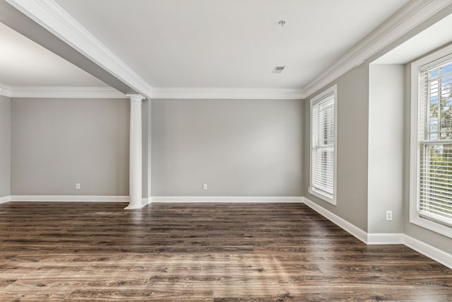 spare room with dark hardwood / wood-style floors, ornate columns, and ornamental molding