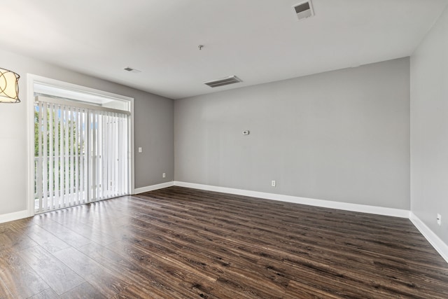 unfurnished room featuring dark wood-type flooring