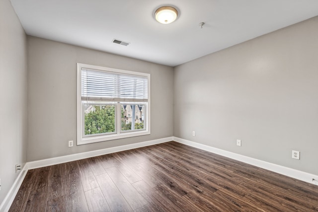 spare room featuring dark hardwood / wood-style floors