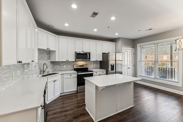 3200 Long Blvd Unit 4, Nashville, TN 37203 - kitchen featuring appliances with stainless steel finishes, dark wood-style floors, tasteful backsplash, white cabinets, and recessed lighting