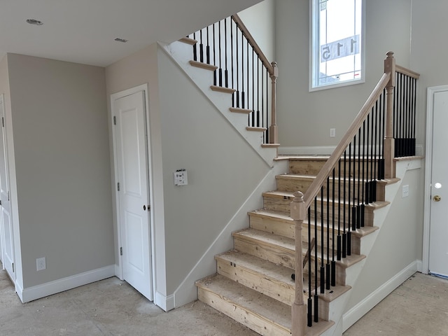 stairway featuring concrete floors