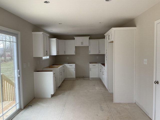 kitchen featuring white cabinets and plenty of natural light