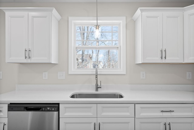 kitchen featuring a sink, white cabinetry, light countertops, and stainless steel dishwasher