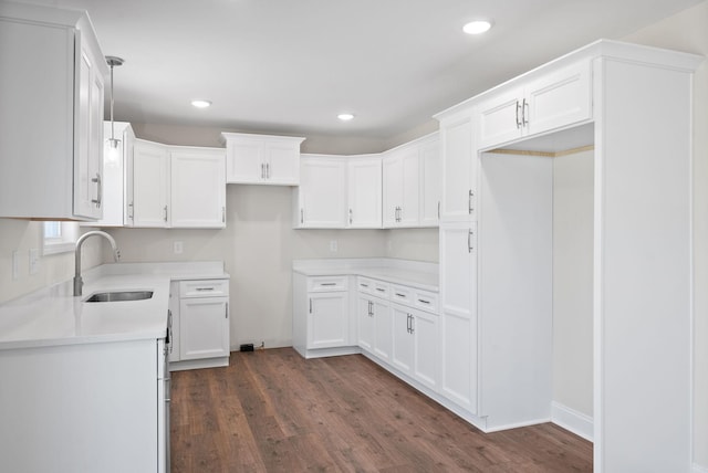 kitchen with white cabinetry, dark wood finished floors, a sink, and recessed lighting