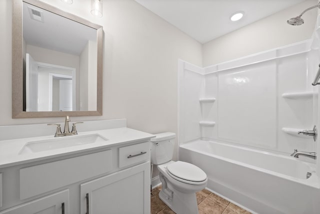 full bath with visible vents, toilet, washtub / shower combination, vanity, and tile patterned floors