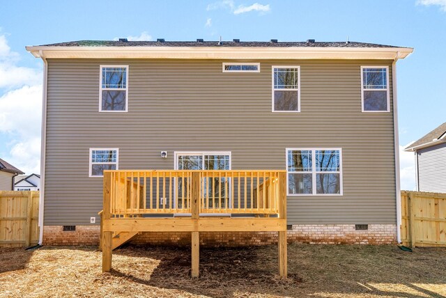 rear view of house featuring crawl space, fence, and a deck