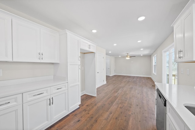 kitchen with recessed lighting, light countertops, stainless steel dishwasher, white cabinetry, and wood finished floors