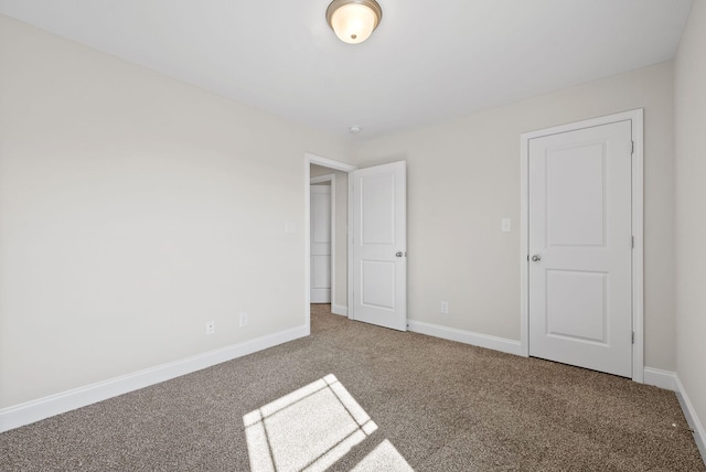 unfurnished bedroom with carpet and baseboards