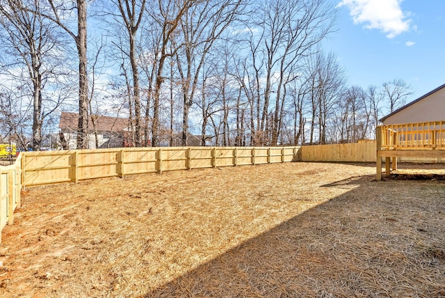 view of yard featuring a fenced backyard and a wooden deck