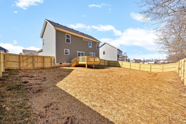 rear view of property featuring crawl space, a fenced backyard, and a wooden deck