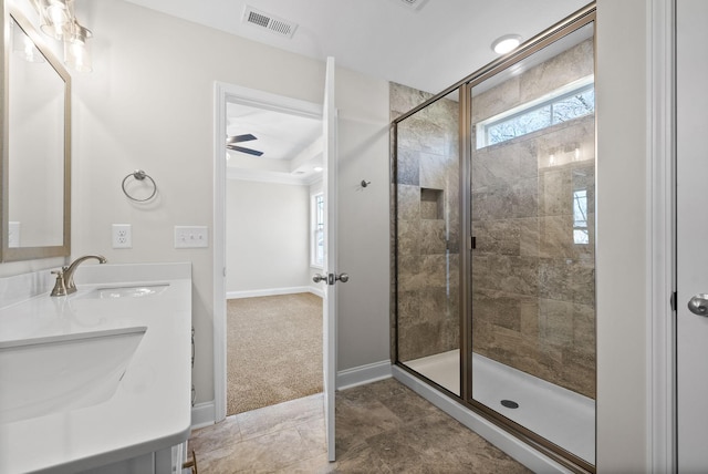 full bath featuring a sink, visible vents, a wealth of natural light, and tiled shower