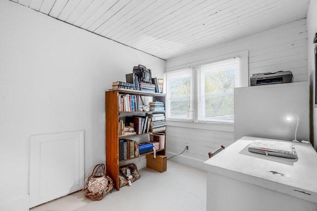 home office featuring wooden ceiling and wood walls