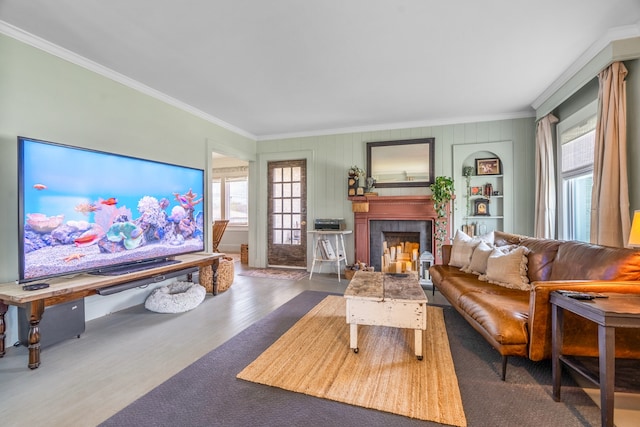 living room featuring a fireplace, crown molding, and a wealth of natural light