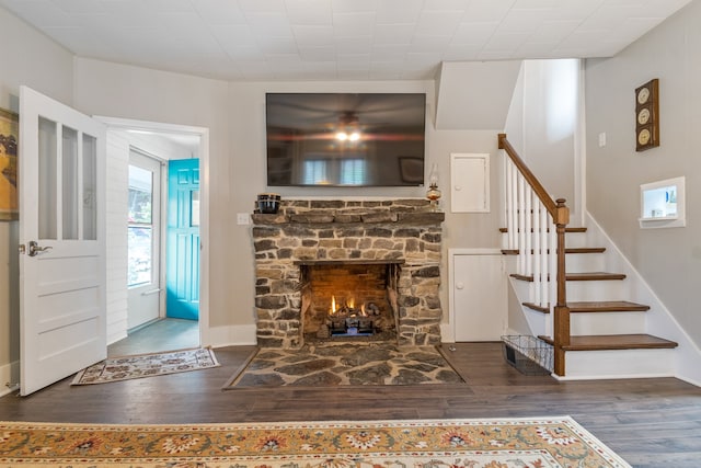 living room featuring a fireplace and dark hardwood / wood-style floors