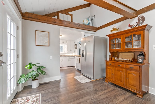 kitchen with beam ceiling, stainless steel fridge, wood ceiling, and dark hardwood / wood-style floors