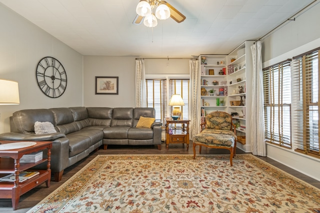 living room with ceiling fan, plenty of natural light, and dark wood-type flooring